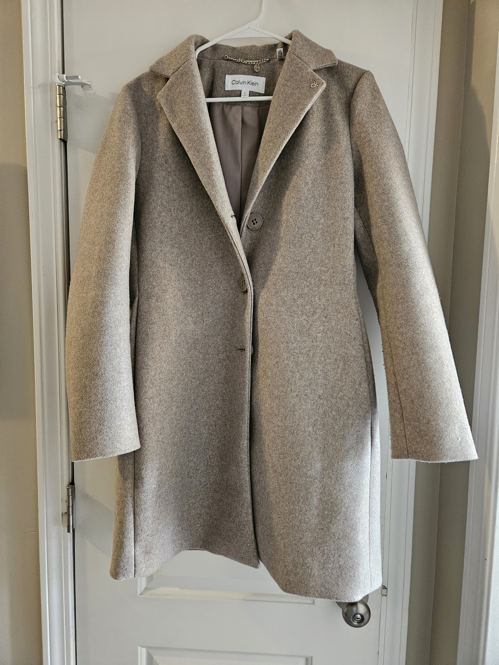 Calvin Klein single-breasted wool blend trench coat in a neutral taupe hue.